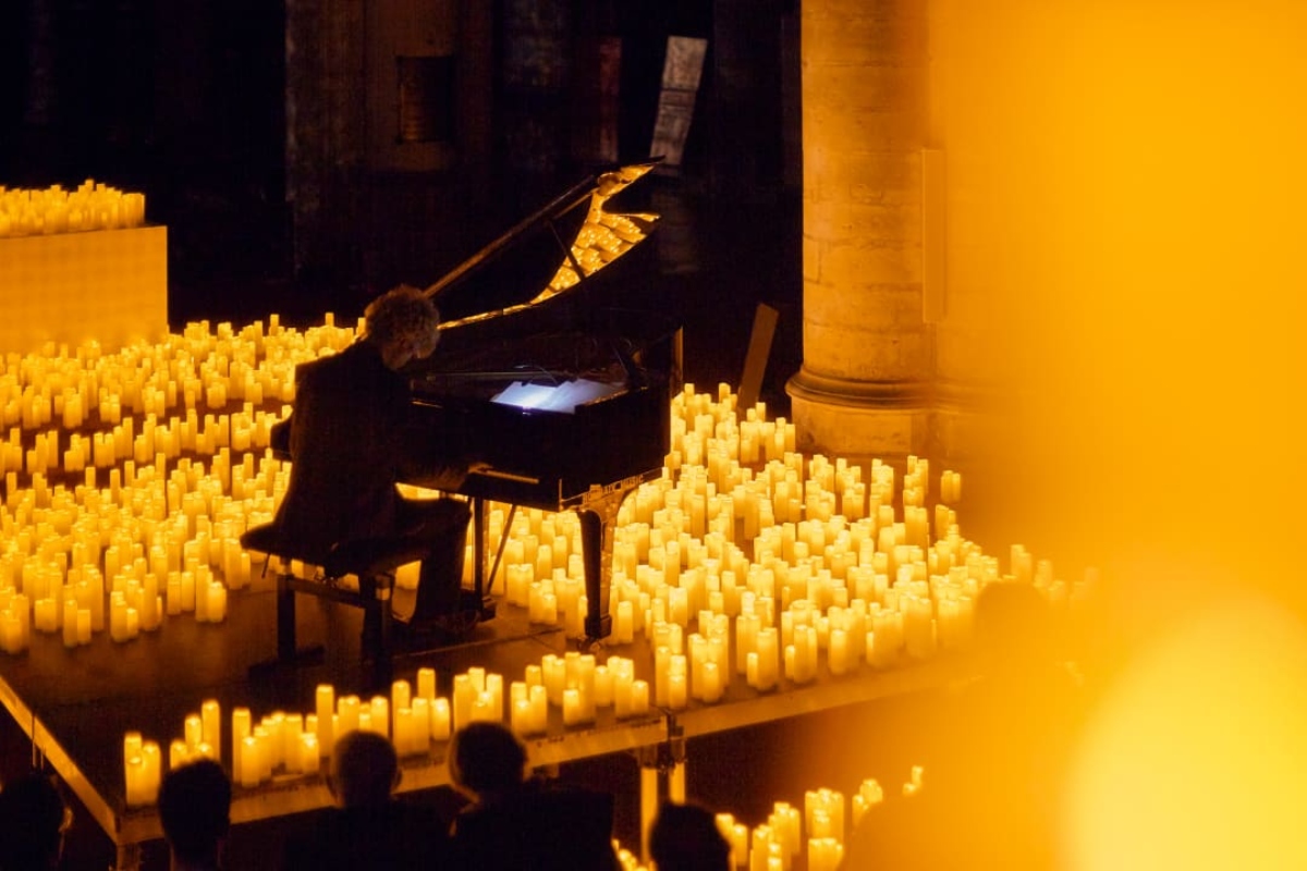 Pianist spielt auf der Bühne aus Meer von Kerzen bei Candlelight-Konzert in Nürnberg