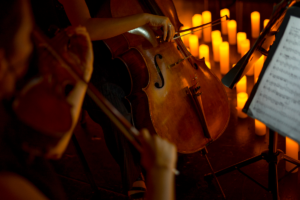 A cellist plays by candlelight