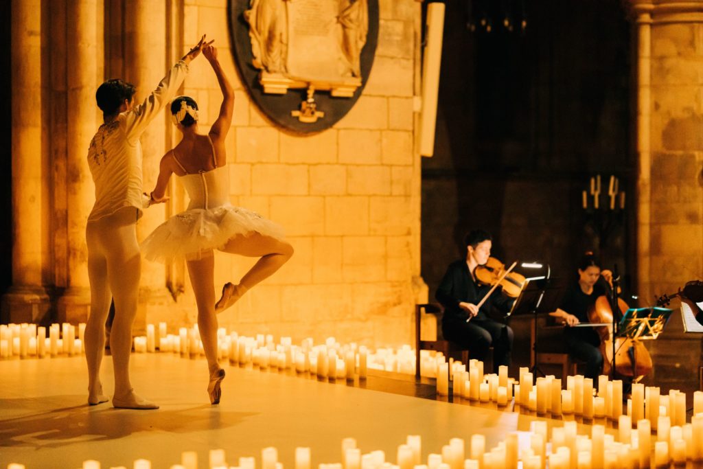 Ballerinas dancing together in front of a string quartet at a Candlelight concert in Sheffield Cathedral.