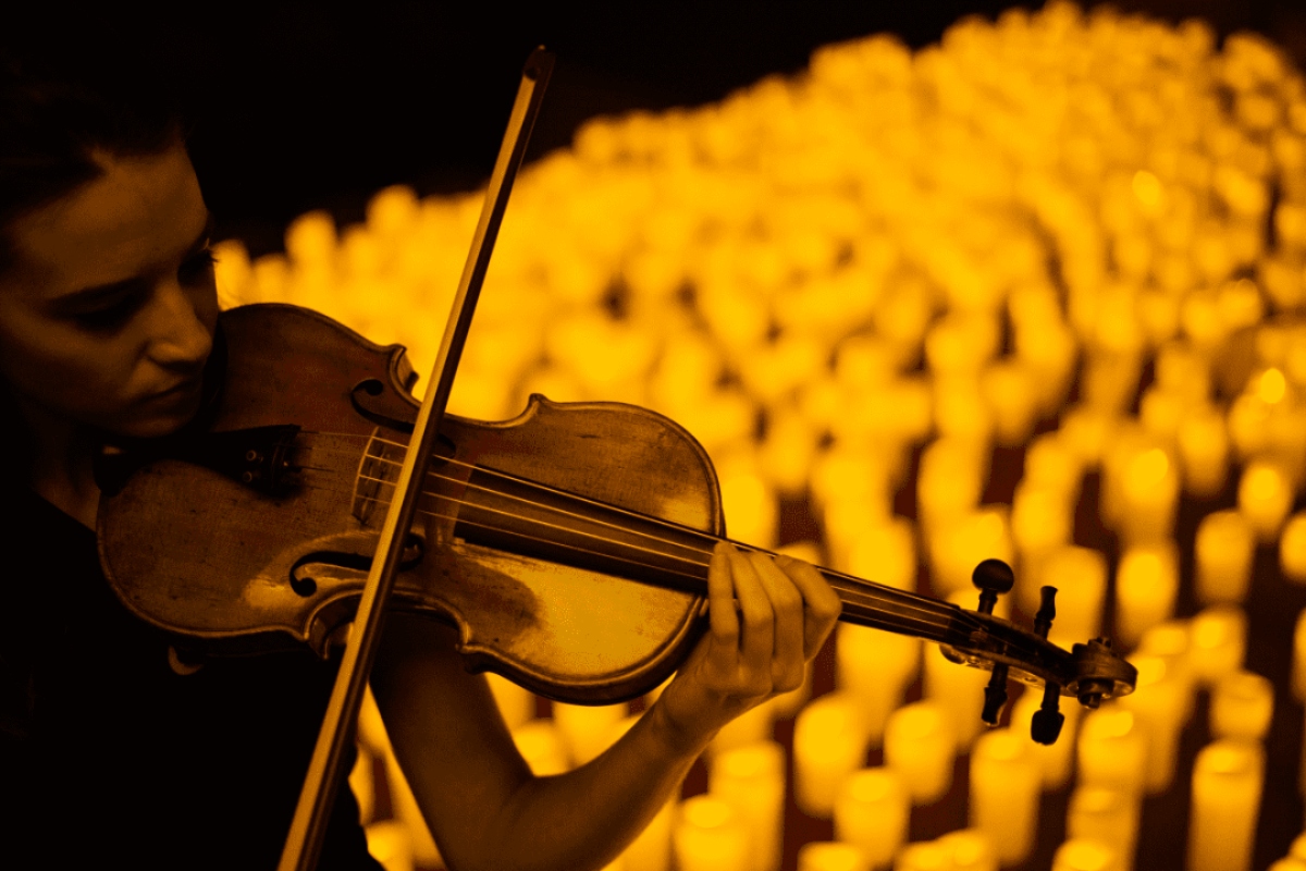 Musikerin spielt Violine in einem Meer von Kerzen bei Candlelight-Konzert in Bremen