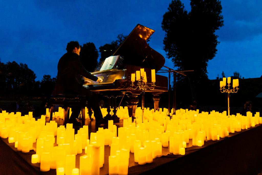 A pianist performing an open-air Candlelight concert.