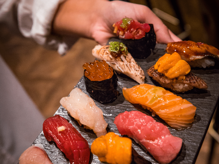 close up of someone holding a platter of sushi for a dining in the dark experience in fort lauderdale