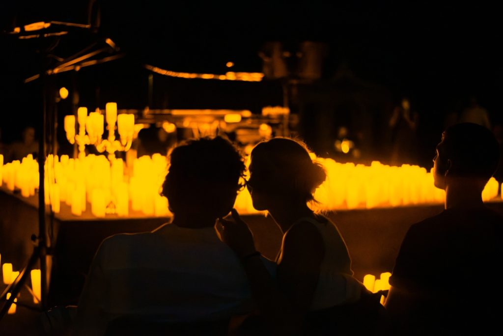 A couple getting close at a Candlelight concert