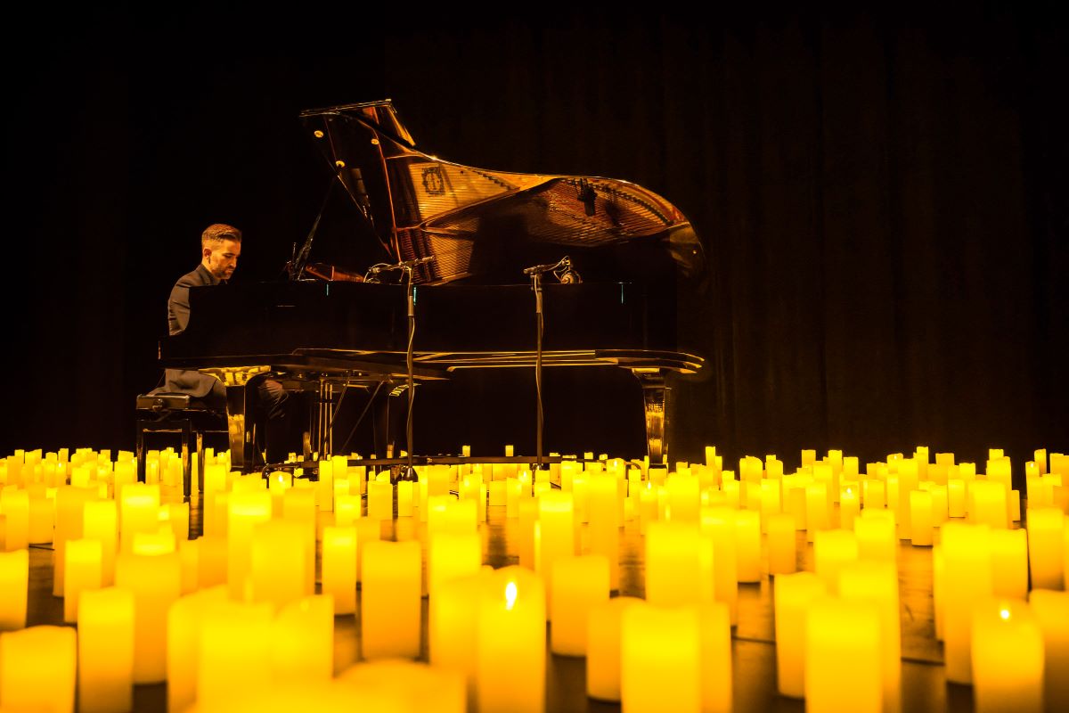 A pianist performing by candlelight.