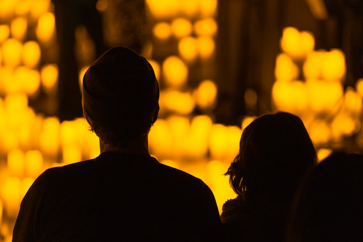 A couple watching a Candlelight concert.