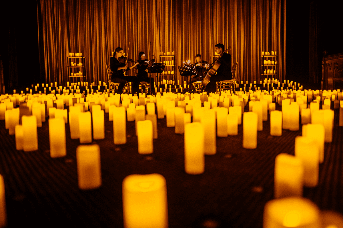 A string quartet performing in a sea of candles