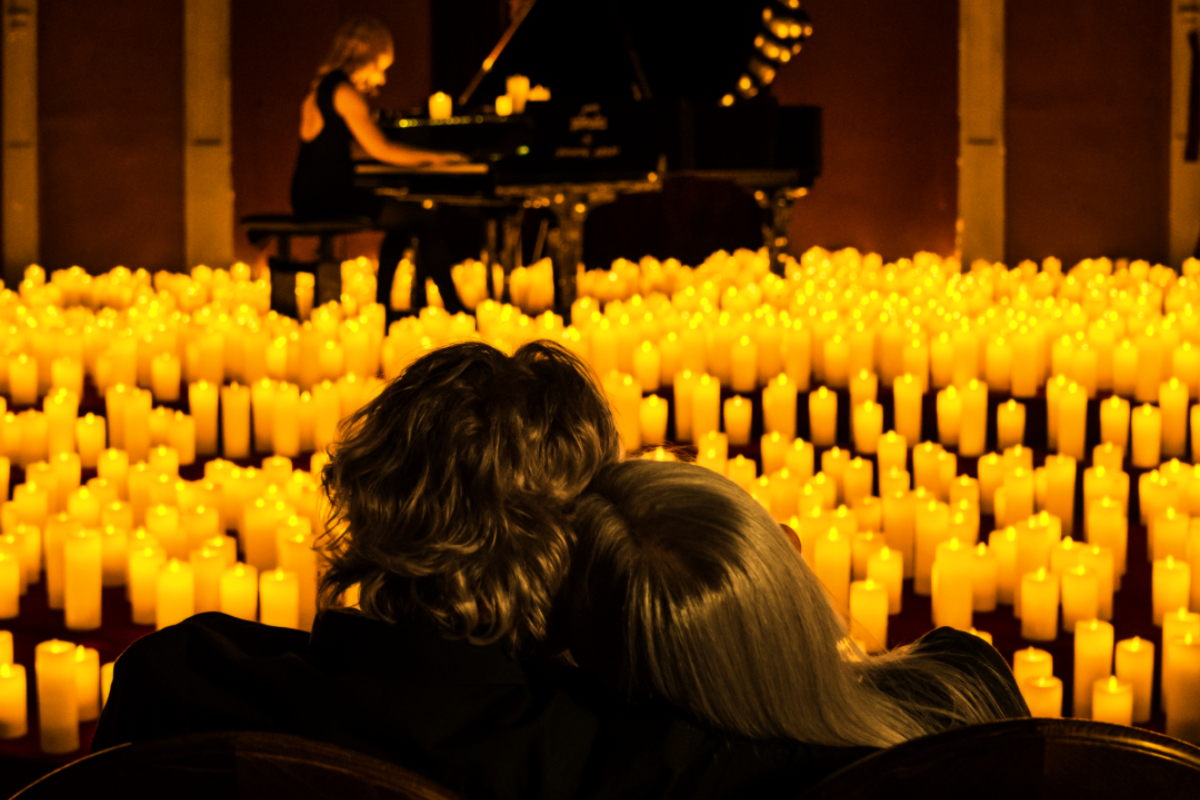 A back shot of a couple enjoying a Candlelight concert
