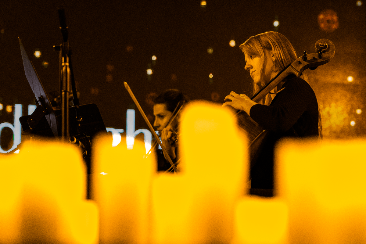 Musicians in a string quartet performing by candlelight
