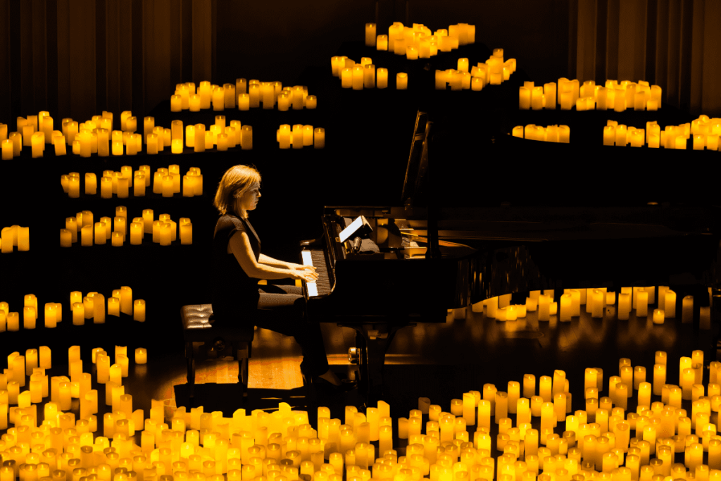 A pianist performed, surrounded by candles at Candlelight. 