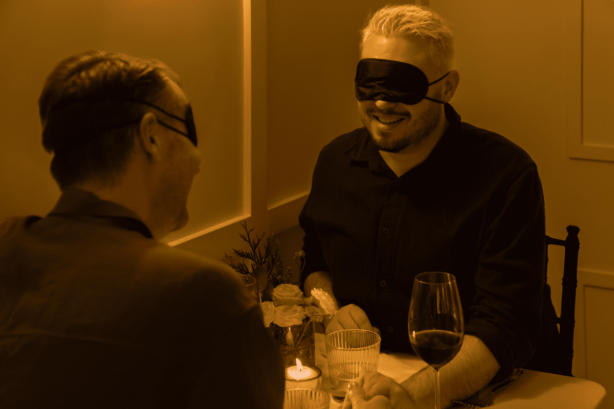 A blindfolded couple dining in the dark 