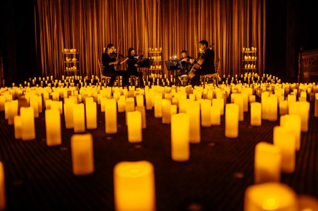 A string quartet performing by candlelight.