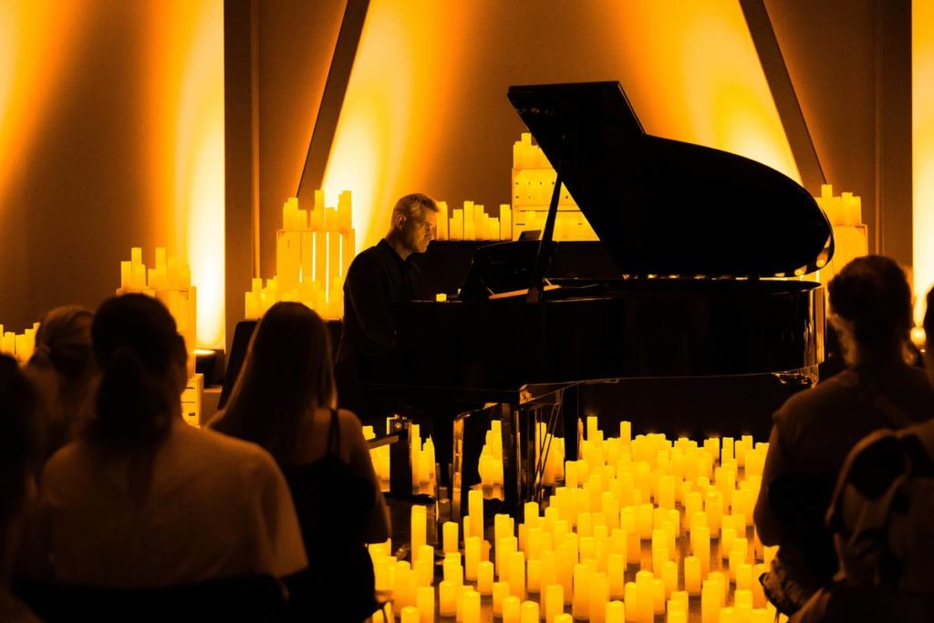 A pianist playing the grand piano at a Candlelight concert